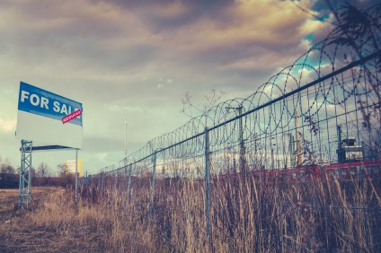 buying vacant land barbed wire fence sold sign