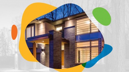 A modern home with brick and windows lit up at dusk