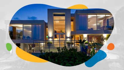 A modern luxury home lit up at dusk