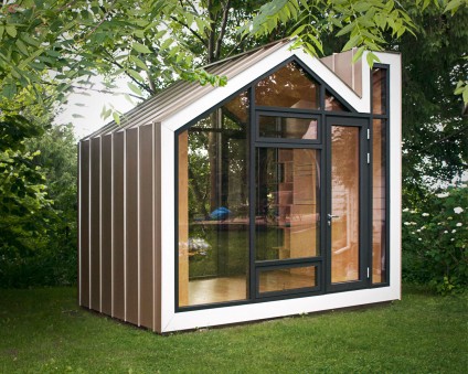 A very small tiny home with a glass exterior