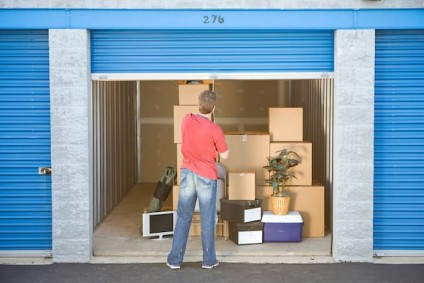 adult child putting stuff in storage