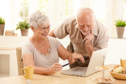 Older couple shopping online. Buying property in another country.