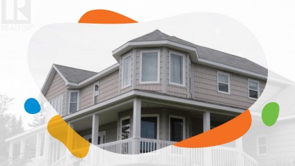 View of a large home with a wrap around porch