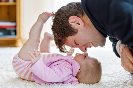 Father kissing baby tiny home living Zolo