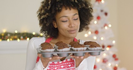 Smiling happy woman in a festive red apron standing in front of