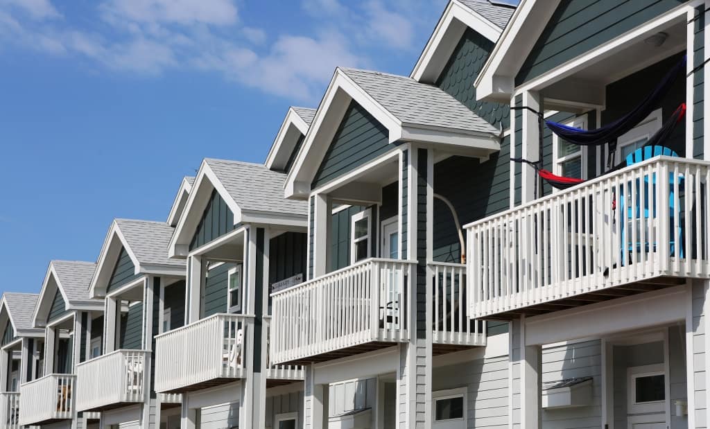 Row of modern new beach style condo/apartments - important to have vacant home insurance