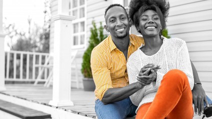 Young couple discussing homebuying on a couch