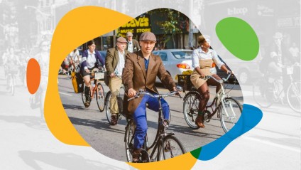 Many people riding bicycles down a street