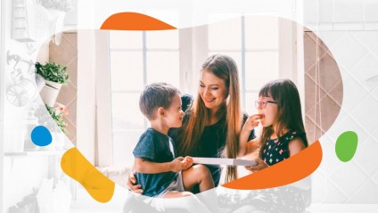 A smiling mother and her children embracing and eating