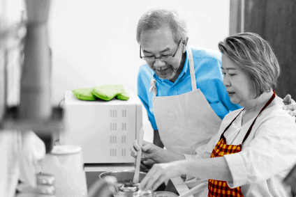 older asian couple cooking together