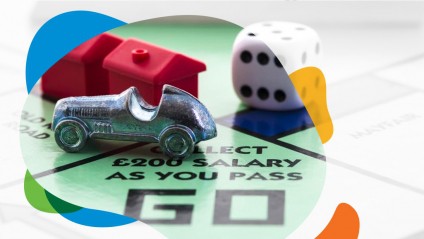 Dice and playing pieces on a Monopoly game board