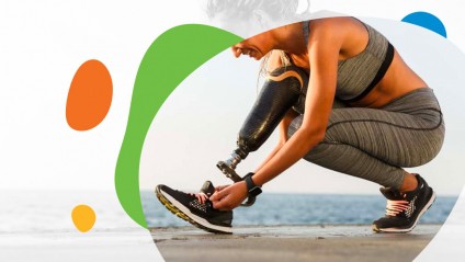 Smiling female athlete tying her shoe on a prosthetic leg