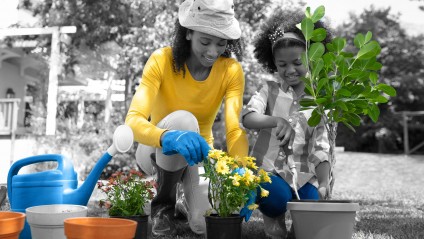 Woman with young girl working in the garden