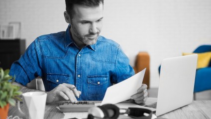 Man calculating using a calculator