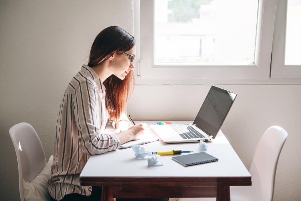 A Young Beautiful Student Girl Does Homework Or Writes A To do L