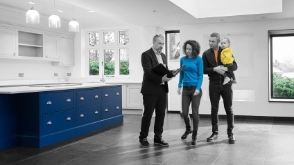 Realtor showing home to family of mom, dad, and toddler