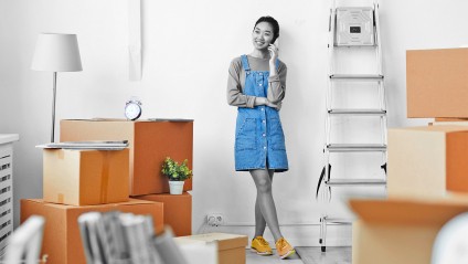 single woman speaking on the phone in her new home