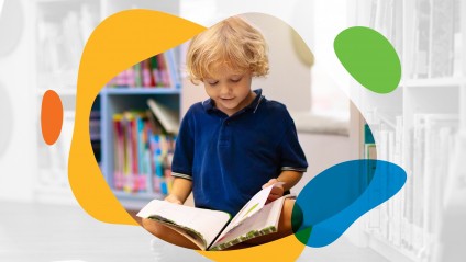 Kid sits in library and reads book