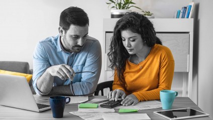 a couple reviewing their finances in order to refinance their mortgage