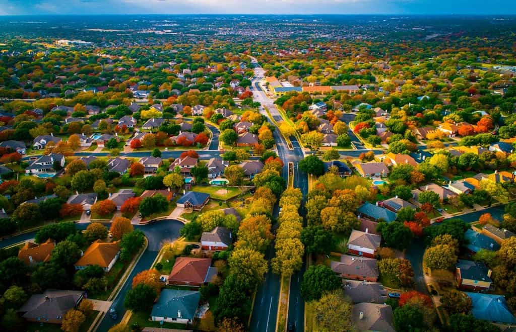 aerial view of urban neighborhood with lots of trees and houses