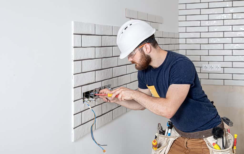 Electrician Builder at work, installation of sockets and switches
