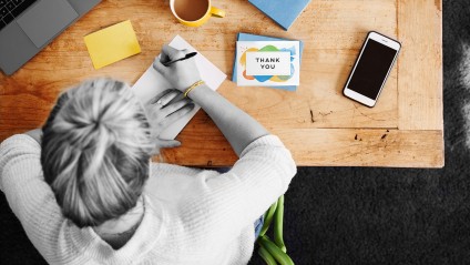 photo of person writing a thank you note
