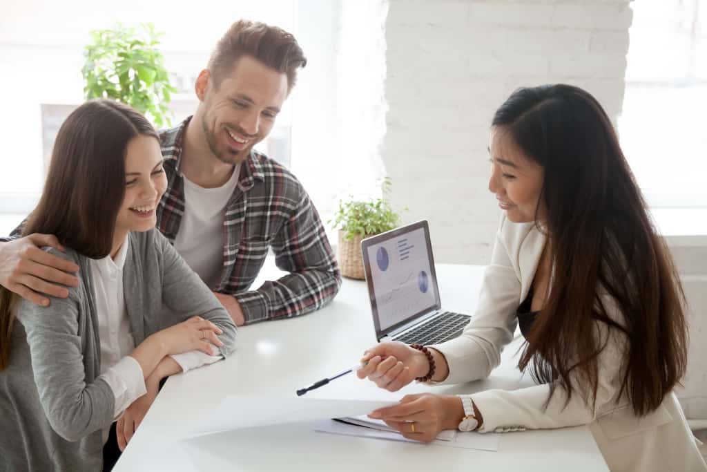 Financial advisor consulting young millennial couple clients customers about buying renting house in a seller's market