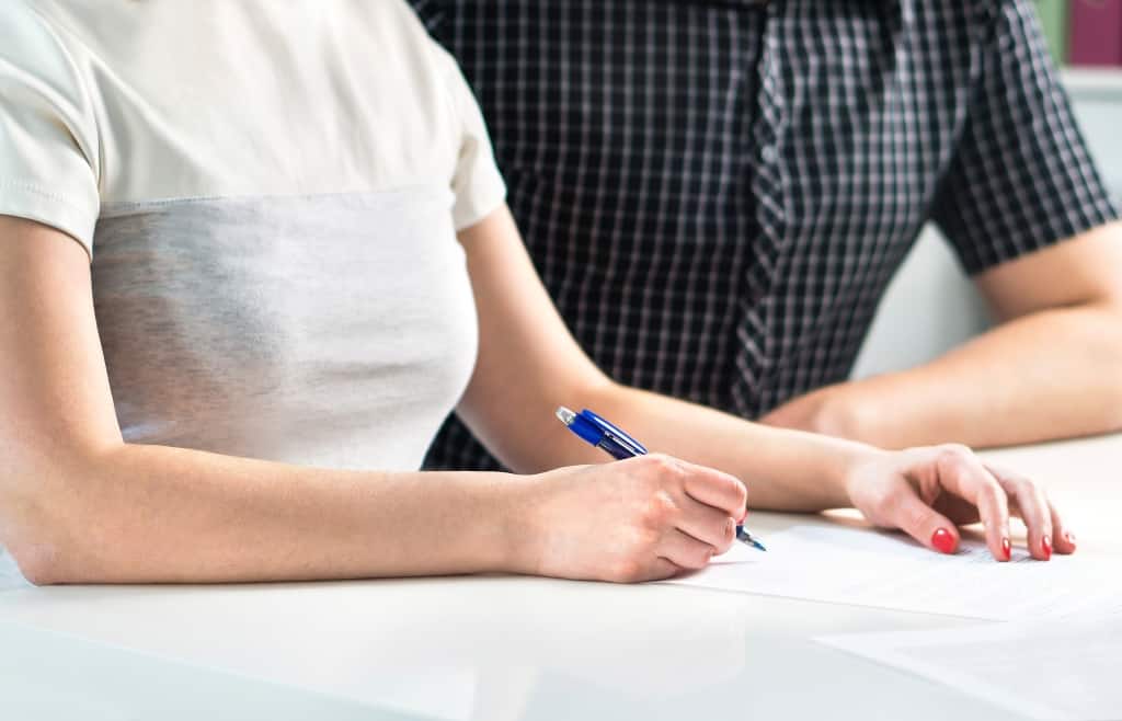 Couple writing a plan, counting family budget or signing contract settlement