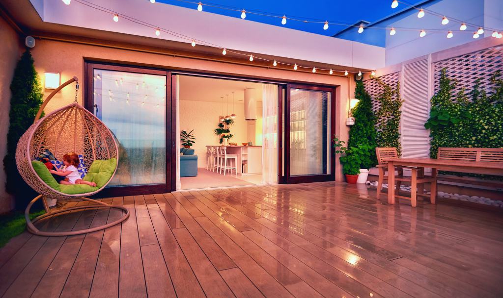 cozy rooftop patio with sliding doors at the evening after the rain