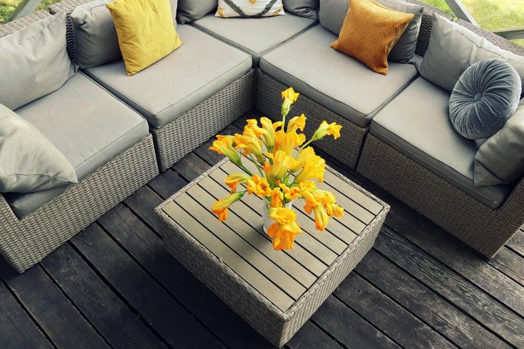 Outdoor furniture lounge group with chairs, sofa and table in a patio