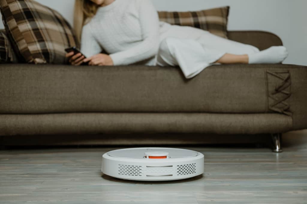 Automatic robotic vacuum cleaner on laminate wood floor, smart cleaning technology
