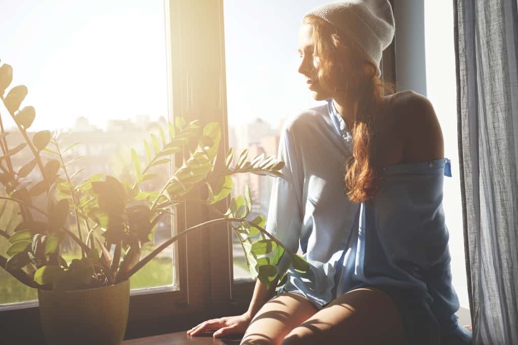 Cropped shot of beautiful female teenager looking at the window