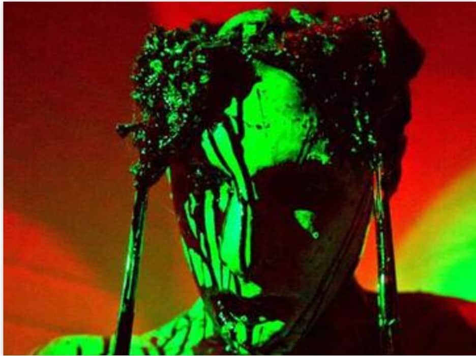 woman with green face paint and gorey makeup