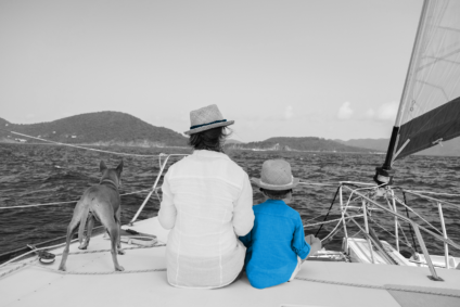 mother, son and dog on a boat