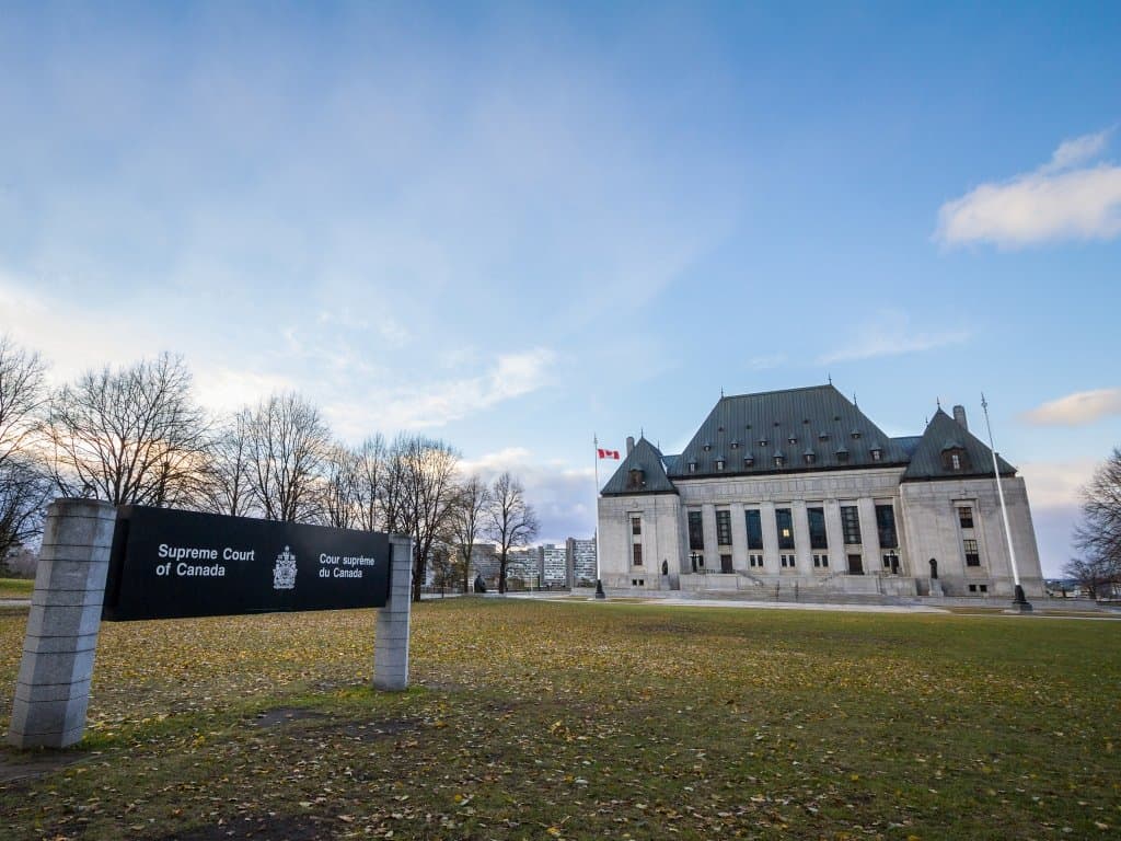 sign stating Supreme Court of Canada with the court building in the background