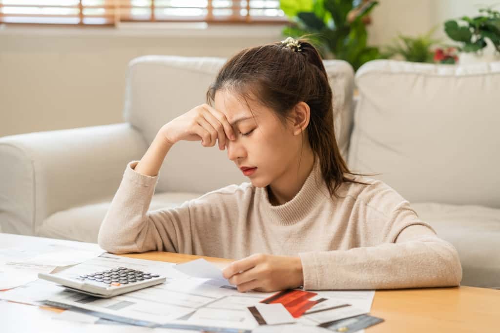 woman appears stressed when calculating