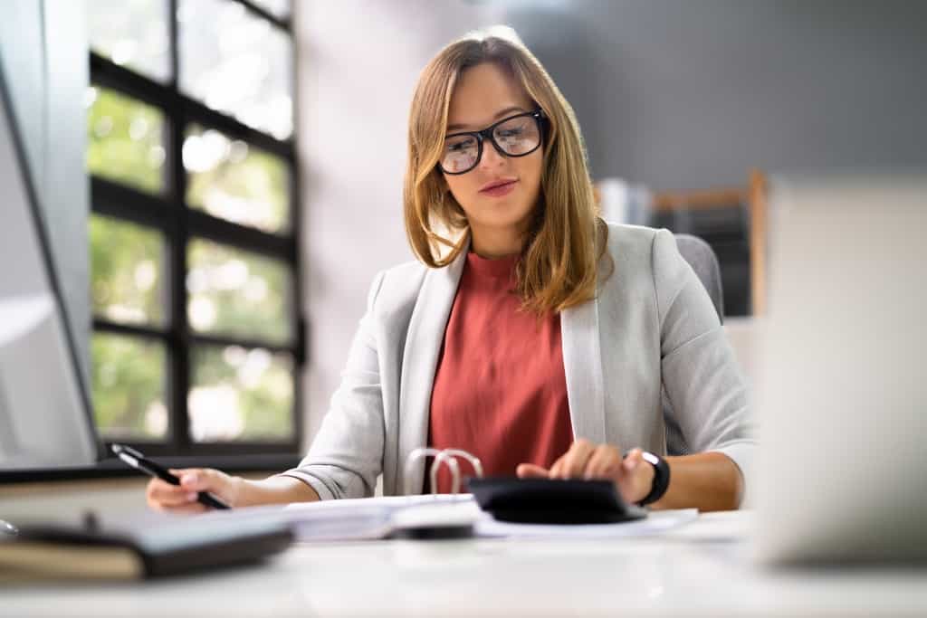 woman working and calculating on a calculator