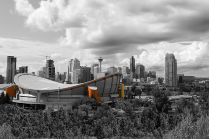 greyscale view of Calgary skyline with the Scotiabank Saddledome