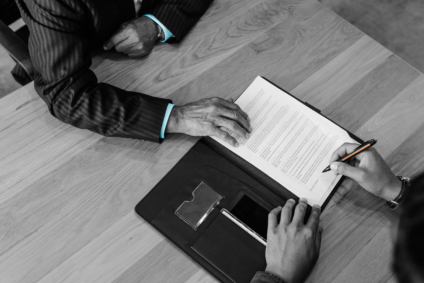 rSigning paperwork with a real estate lawyer